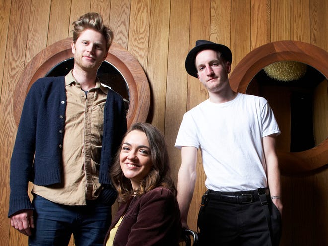 FILE - In this Jan. 18, 2013 file photo, from left, Wesley Schutlz, Neyla Pekarek and Jeremiah Fraites of The Lumineers pose at the Dream Downtown Hotel in New York. Fraites says that a picture of a New Jersey newspaper columnist is the secret to the bands' success. He posted a picture of his keyboard with the picture of The Record political columnist Herb Jackson to the folk rock band's Facebook, Instagram and Twitter accounts on Thursday, March 6, 2015. He says that he taped the picture to his keyboard 10 years ago and that “looking at him assures me creativity will flow.” (Photo by Dan Hallman/Invision/AP, File)