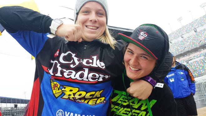 Amateur Supercross racers Mackenzie Tricker, left, and Marissa Markelon have some fun before going into battle Sunday at Daytona International Speedway.