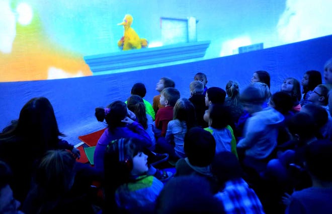 Students view Sesame Street Big Bird in an inflatable indoor planetarium at Queens Creek Elementary School Friday morning where they will be taken on a tour through the night sky.
