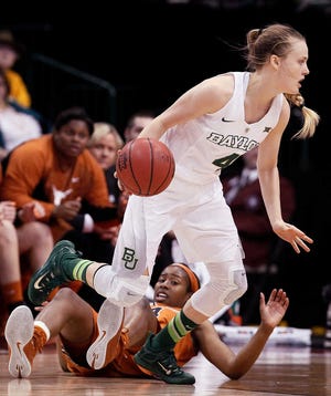 Texas guard Ariel Atkins falls down as Baylor guard Kristy Wallace (4) looks for room during the first half of an NCAA college championship basketball game of the Big 12 Conference tournament, Monday, March 9, 2015, in Dallas. (AP Photo/Brandon Wade)