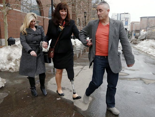 Boston Marathon bombing survivors Heather Abbott, of Newport, left, and Karen Rand, center, are escorted from federal court, after attending the trial of Boston Marathon bombing suspect, Dzhokhar Tsarnaev.