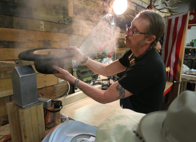 Gregory Westbrook fashions a pencil roll on a hat brim using steam at Will Leather Goods in Eugene. The company’s latest store is opening in a boxcar at the Fifth Street Public Market in downtown Eugene. (Brian Davies/The Register-Guard)