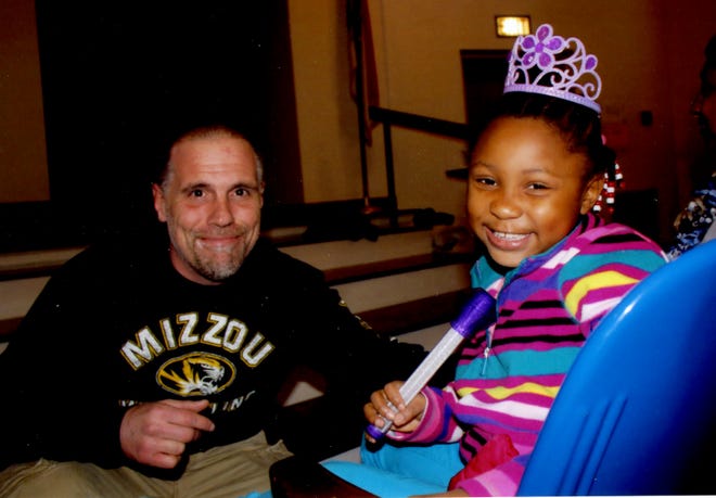 P.E. Teacher Brian Blow with Kaleigh Galette, a kindergarten student in Molly Kendrick's class who was diagnosed with a rare form of leukemia in 2011 but has been cancer free for a year.