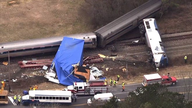 In this frame grab from video provided by WTVD-11, authorities respond to a collision between an Amtrak passenger train and a truck, Monday, March 9, 2015, in Halifax County, N.C. According to  Halifax  County Sheriff Wes Tripp, none of the injuries appeared to be life-threatening. (AP Photo/WTVD-11)