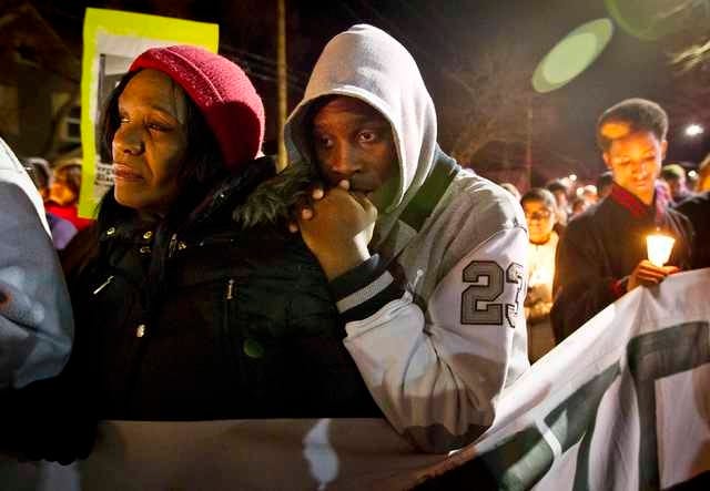 Tramale Robinson rests on the shoulder of his mother, Lynn Robinson, during a candlelight vigil for Tony Robinson Jr. in Madison, Wis., on March 8, 2015. Activists protested for a third day in Madison on Sunday over the fatal shooting of an unarmed black teenager by a white policeman, the latest in a string of killings that have intensified concerns of racial bias in U.S. law enforcement. REUTERS/Ben Brewer