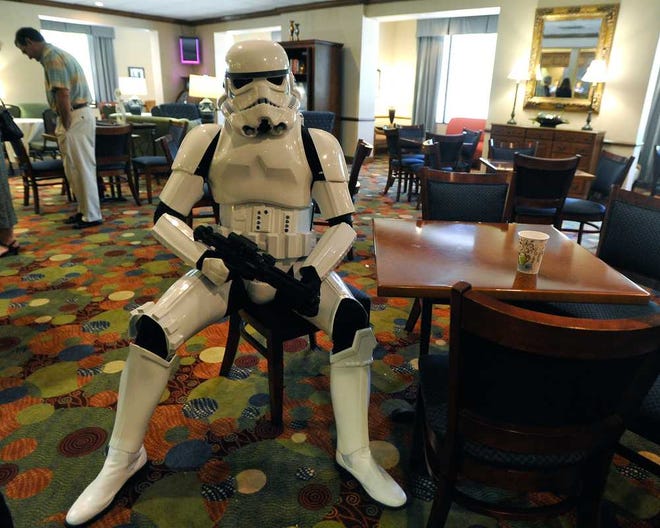 Leonard Gude, dressed as a stormtrooper, sits inside the lobby of the Holiday Inn Express for AthCon on Saturday, May 3, 2014, in Athens, Ga. (AJ Reynolds/Staff, @ajreynoldsphoto)