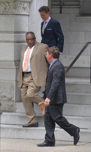 This photo taken Aug. 11, 2014, shows former Savannah-Chatham police Chief Willie Lovett, left, leaving the federal courthouse with his attorneys Joshua Lowther, top, and William Dow Bonds, right. Savannah's former police chief will collect a six-figure pension while serving time in federal prison. City Council members were told Thursday, Feb. 19, 2015, that Lovett will keep his pension, worth $129,487 a year before taxes. (AP Photo/Savannah Morning News, Steve Bisson)