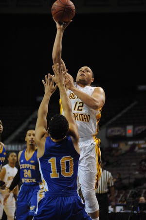 Bethune-Cookman's Mikel Trapp shoots over Coppin State's Christuan Kessee during Tuesday's Mid-Eastern Athletic Conference opening-round game in Norfolk, Virginia.