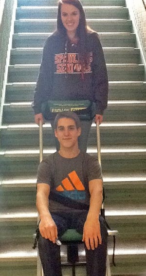 Spaulding students Austin LeBlanc and Sydney Lord demonstrate an escape chair.