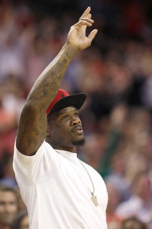 FILE- In this March 4, 2015, file photo, Houston Texans wide receiver Andre Johnson acknowledges the crowd during the second half of an NBA basketball game between the Houston Rockets and the Memphis Grizzlies in Houston. Johnson has been released by the Houston Texans, a person with knowledge of the move told The Associated Press, Monday, March 9, 2015. The person spoke on condition of anonymity because no formal announcement had been made by the team. (AP Photo/Pat Sullivan, File)
