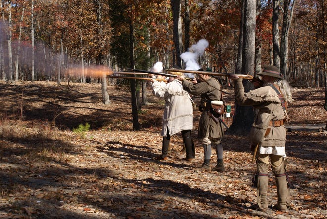 Members of the Backcountry Militia at Kings Mountain National Military Park fire a volley.
