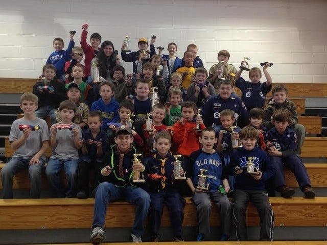 PROUD RACERS —  Cub Scouts show off their race cars and trophies after the 2015 Montgomery District Pinewood Derby Race. (Contributed photo)
