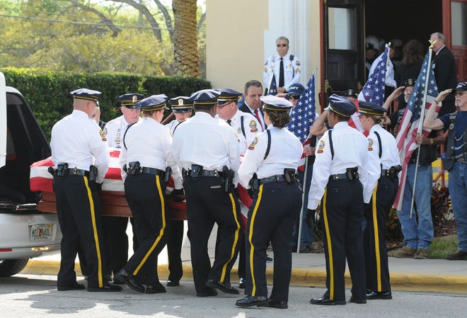 The casket for Lt. Joseph J. Muffoletto is carried inside by an Honor Guard at the Basilica of St. Paul for funeral services, in Daytona Beach, on Thursday morning.