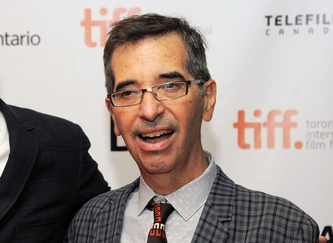 In this Sept. 6, 2013 file photo, director Richard Glatzer poses at the premiere of the film “The Last of Robin Hood” at the Toronto International Film Festival at the Isabel Bader Theater in Toronto. Glatzer, who directed “Still Alice,” a film that garnered actress Julianne Moore an Oscar for best actress last month, died Tuesday, March 10, in Los Angeles after a four-year battle with ALS. He was 63.
