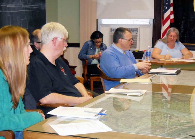 Police Chief Timothy Parisi, center, discusses the proposal to consolidate local police departments. Also shown are Animal Control Officer Melissa Bennett, left, and Fire Chief James Trevett. At far right is Village Clerk Cindy Kennedy. TELEGRAM PHOTO/DONNA THOMPSON