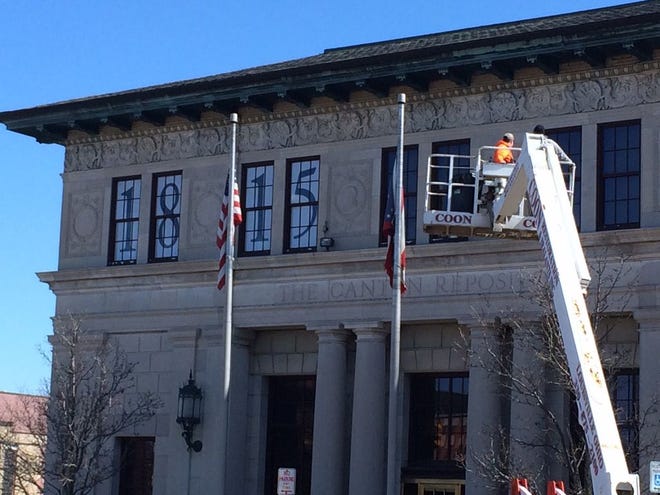 Bicentennial decorations were added to the front of The Repository's building in downtown Canton on Thursday, as the newspaper prepares to celebrate its bicentennial