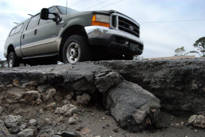 A truck drives by the intersection of Cunningham Boulevard and Jaycee Street Monday in Havelock where a fairly deep rut has formed at the edge of the roadway. Spring is pothole season on area roads, as pavement expands with warming temperatures, causing cracks that can sometimes break off in chunks, creating potholes.