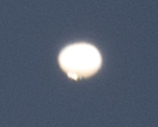 This zoomed in view of the drifting object in Thursday morning's sky is a small portion of a frame shot with a 500mm telephoto lens around 9:30 a.m. The object appears to be a balloon and was easily seen as it hung just above the sun at that time. The object was slowly drifting southeast. JH
