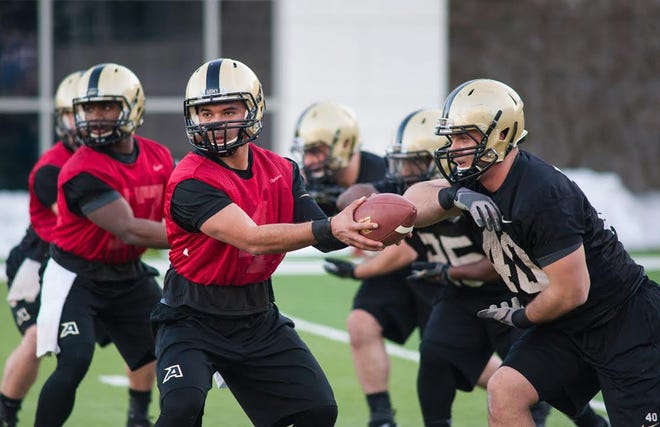 Army's Matt Kaufmann (4) runs a drill with Matt Giachinta (40) during the first day of spring football practice Thursday. KELLY MARSH/FOR THE TIMES HERALD-RECORD