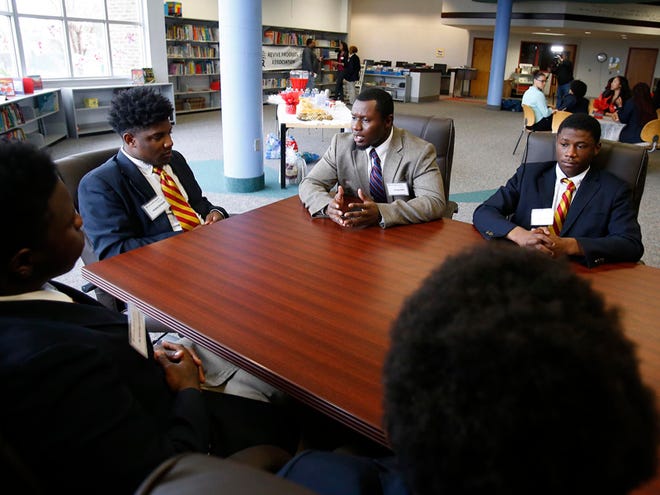 Trevin Fluker, center, President of Revive Progress, speaks with Original Kirkland, left, Tavon Brown, right, and other seniors during the Revive Progress mentor program through Success Prep at Oak Hill School in the school's library in Tuscaloosa, Ala. on Thursday March 12, 2015.