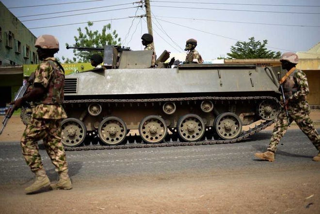 Nigerian troops patrol in Mubi, some 15 miles west of the Cameroon border. Nigerian troops recaptured Mubi from Boko Haram militants in February.  Associated Press