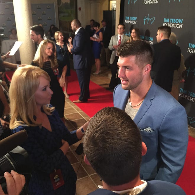 Tim Tebow talks to the media on the red carpet at the Tim Tebow Foundation Celebrity Gala and Golf Classic at TPC Sawgrass in Ponte Vedra Beach.