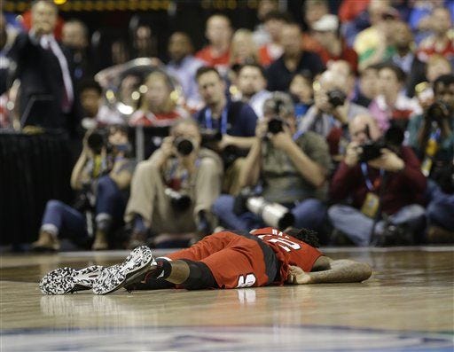 N.C. State's Cat Barber lays on the court after being injured during the second half of Thursday night's loss to Duke.