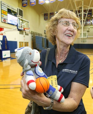 News-Journal/Nigel Cook
Embry-Riddle basketball fan Joan Spiroff clutches her doll "Lucky" after ERAU basketball advanced to the finals of the NAIA Tournament, Saturday, March 14, 2015.