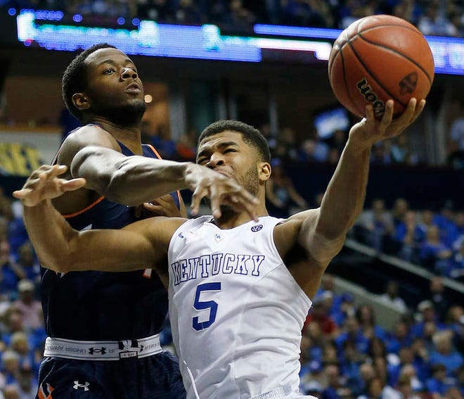 Kentucky guard Andrew Harrison (5) drives on Auburn center Trayvon Reed (4) during the second half of an NCAA college basketball game in the semifinal round of the Southeastern Conference tournament, Saturday, March 14, 2015, in Nashville, Tenn. (AP Photo/Steve Helber)