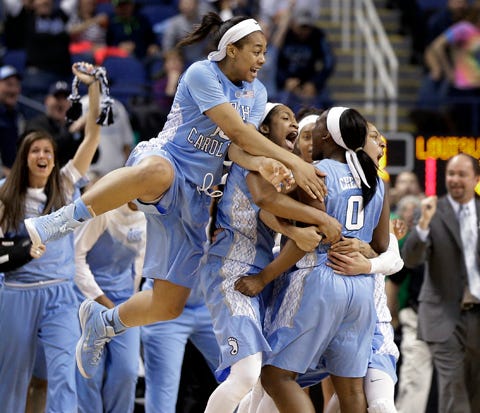 North Carolina’s Jamie Cherry (0) is congratulated by teammates after making a 3-point basket against Louisville at the end of regulation in an NCAA college basketball game in the quarterfinals of the Atlantic Coast Conference women's tournament in Greensboro March 6. Former West Craven basketball standouts Jamie Cherry, Aaron Tate and Josh Cuthbertson are playing in NCAA Division-I postseason tournaments this season.