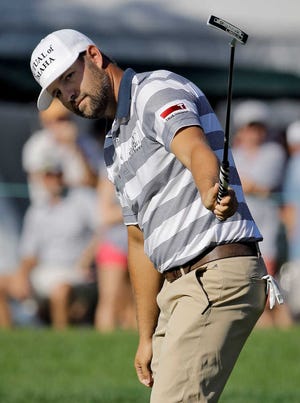 Ryan Moore raises his putter as he makes a birdie putt on the 16th hole during the third round of the Valspar Championship golf tournament Saturday, March 14, 2015, at Innisbrook in Palm Harbor, Fla. (AP Photo/Chris O'Meara)