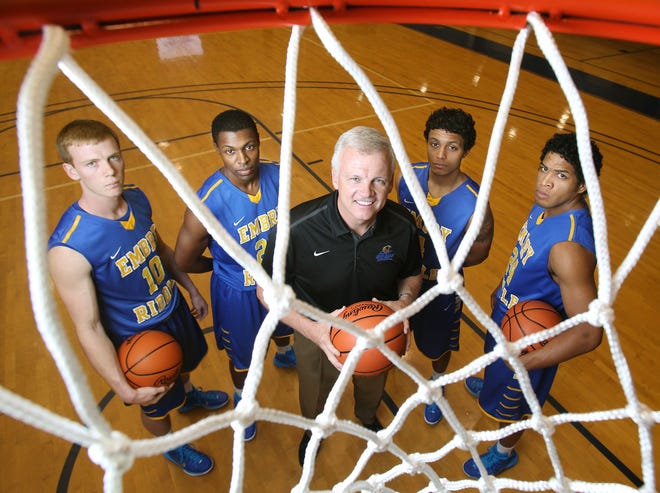 Embry-Riddle head basketball coach Steve Ridder poses with players Reed Ridder, left, Jason Powell, Dalton Barnes and DeForest Carter.