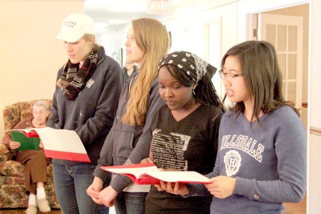Hillsdale College students Kat Vael (left), Jordyn Moore, Monicah Wajiru, Andrea Lee and Danny Drummond (not pictured) led residents of Drew's Place Village in several hymns Friday. JASON DAFNIS PHOTO
