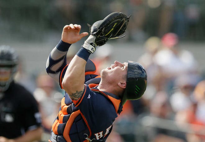 Houston Astros catcher Tyler Heineman catches a popup hit by Washington Nationals' Dan Butler during the eighth inning of a spring training exhibition baseball game in Kissimmee, Fla., Sunday, March 15, 2015. (AP Photo/Carlos Osorio)