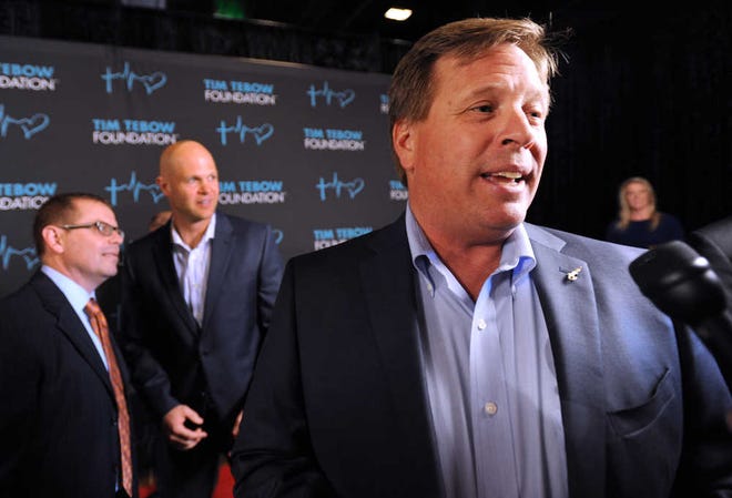 Florida football coach Jim McElwain, right, speaks as he arrives for the Tim Tebow Foundation Celebrity Gala and Golf Classic, Friday, March 13, 2015, in Ponte Vedra Beach, Fla. (AP Photo/The Florida Times-Union, Bob Mack)