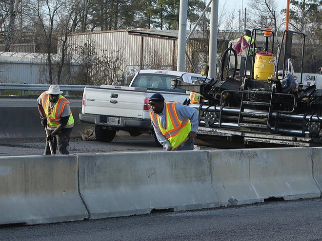 Workers make repairs on a local highway.