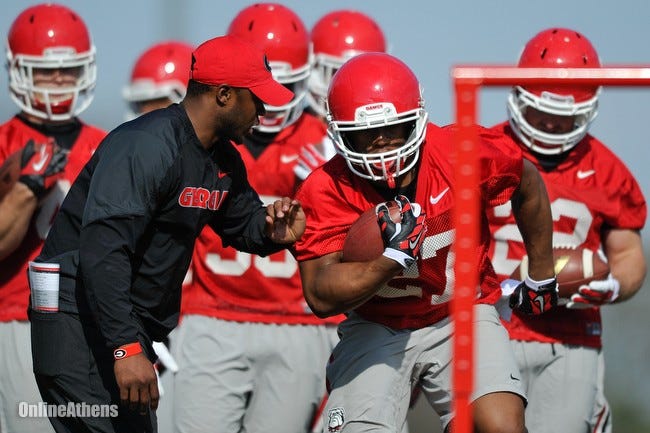 Georgia running back Nick Chubb (27) runs a drill while instructed by running back coach Thomas Brown during Georgia's first spring football practice on Tuesday, March 17, 2015, in Athens, Ga.