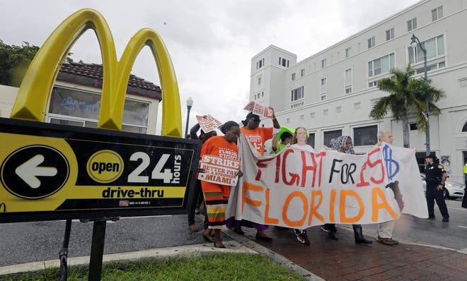 People protest Dec. 4 for higher wages outside a McDonald's restaurant in Miami. McDonaldís workers in 19 cities have filed complaints over burns from hot grills and fryers and other workplace hazards, according to labor organizers. The complaints are the latest move in an ongoing campaign to win pay of $15 an hour and unionization for fast-food workers, in part by publicly pressuring McDonaldís to come to the bargaining table.

Alan Diaz/Associated Press file