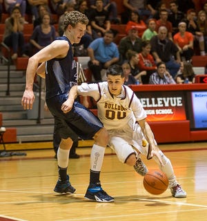 Morenci's Alex Thomas (00) dribbles against Hillsdale Academy's Noah Kalthoff on Monday during a Class D regional semifinal game at Bellevue. Morenci won 48-36.