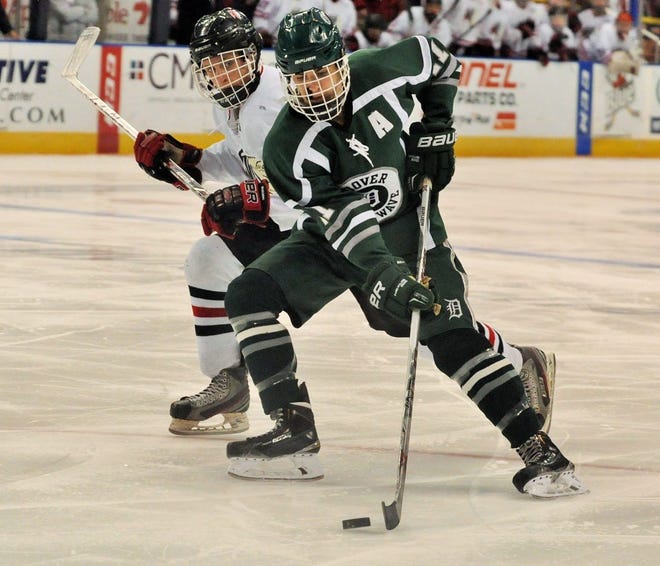 Dover’s Cam Crowley, front, tries to skate around Spaulding’s Kam Kondrup during Saturday’s Division II championship in Manchester.