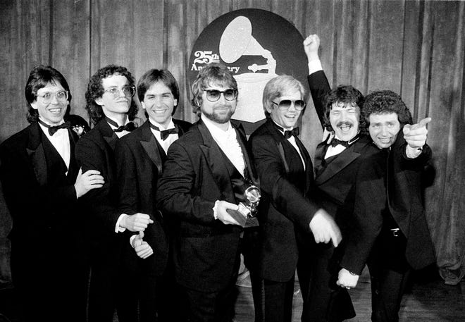 In this Feb. 23, 1983, photo, band members, from left, Jeff Porcaro, Steve Porcaro, Michael Porcaro, Dave Paich, Dave Herngate, Bobby Kimball and Steve Lukather, of Toto pose after winning six Grammys during the 25th annual Grammy Awards presentation in Los Angeles.