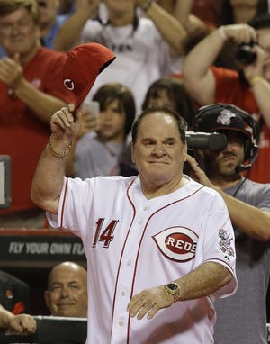 FILE - In this Sept. 6, 2013, file photo, former Cincinnati Red great Pete Rose walks onto the field during ceremonies honoring the starting eight of the 1975-76 World Champion Reds following a baseball game between the Cincinnati Reds and the Los Angeles Dodgers in Cincinnati. Rose has submitted a new request to be reinstated to baseball, according to new Commissioner Rob Manfred. After meeting with the Los Angeles Dodgers on Monday, March 16, 2015, Manfred said "I do have a formal request from Pete. (AP Photo/Al Behrman, File)