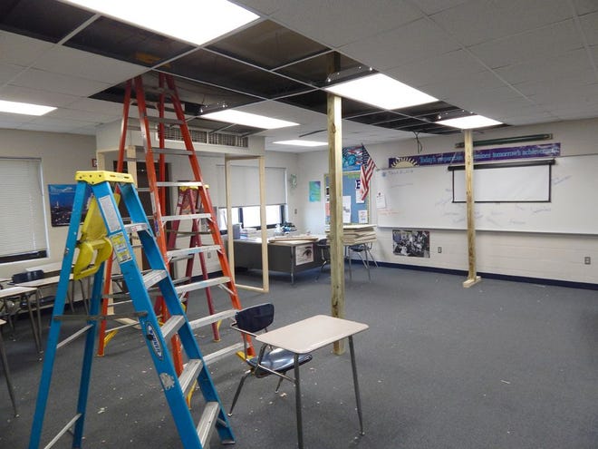 The ceiling above a classroom in Brimley High School still sags slightly after a partial roof collapse Sunday. Although no more damage is expected, an engineer recommended adding the timbers for additional support.