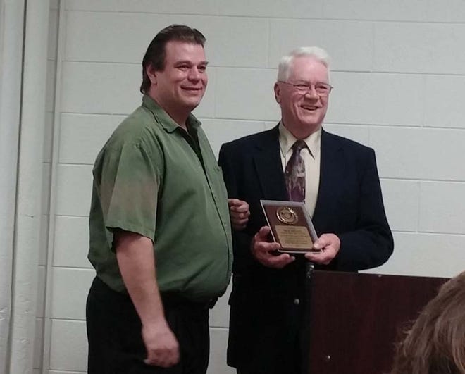 Tim Berger, left, owner of Tim & Shelly’s 2nd St. Bar and Grill, receives the 2014 Civic Achievement Award from 1st Ward Alderman Dennis Gould at the Chillicothe Chamber of Commerce Banquet on Saturday at Pearce Community Center.