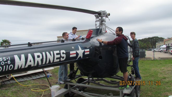 Eric Cracey, far right, a University High School student, joins a group of Embry-Riddle students March 7 in washing a helicopter at the DeLand Naval Air Station Museum. ERAU students are, from left, Hunter Ellis, Jethro Magallon and Alex Olmeta. The HO5S-1 helicopter, given to the museum by Orlando Helicopter Airways, was part of Marine Squadron VMO-6 in the Korean War, evacuating wounded men to field hospitals and to the Hospital Ship “Repose” in Inchon Harbor. The “Chopper” is on view in the museum’s Restoration Building.