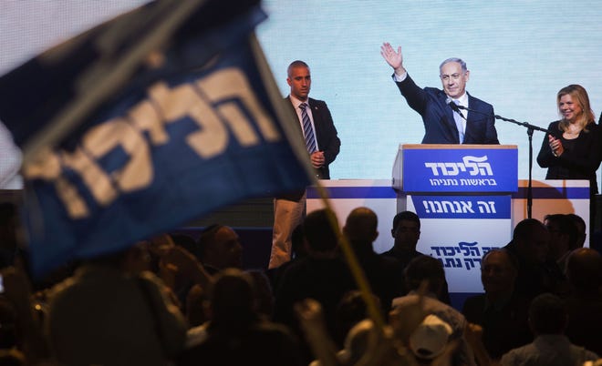 Israeli Prime Minister Benjamin Netanyahu greets supporters at the party’s election headquarters in Tel Aviv. Wednesday, March 18, 2015. Netanyahu’s ruling Likud Party scored a resounding victory in the country’s election, final results showed Wednesday, a stunning turnaround after a tight race that had put his lengthy rule in jeopardy.