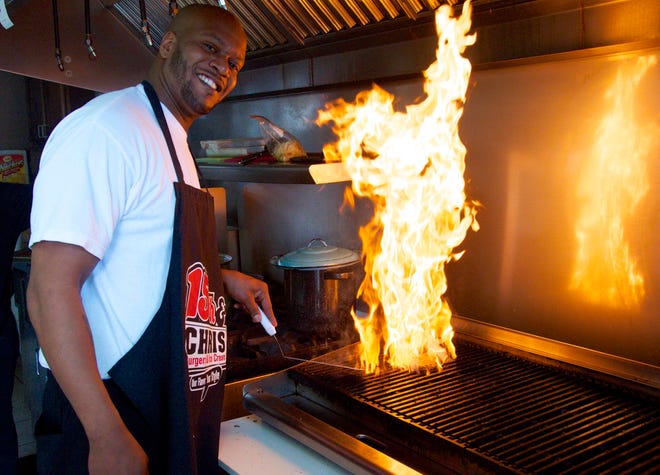 James Purifoy, owner of 15th & Chris, heats up the grill Friday, March 13, 2015, at his restaurant, 201 15th Ave., Rockford.

KEVIN HAAS/RRSTAR.COM