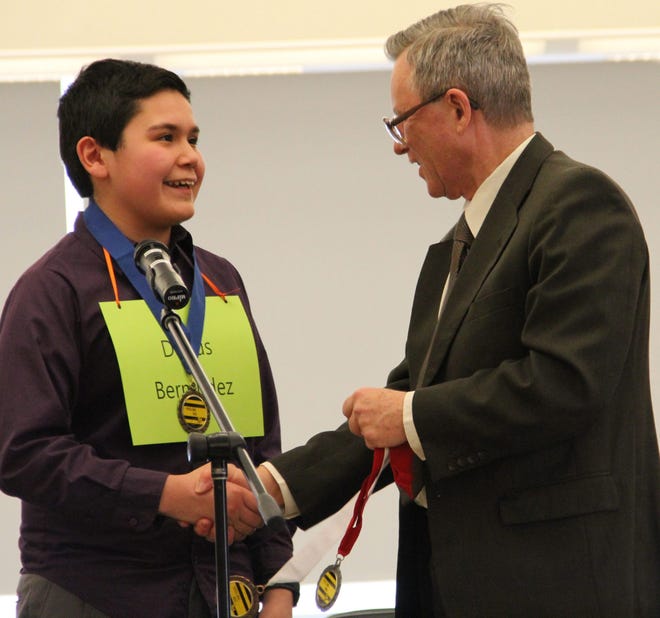 Darius Bermudez was determined to win the Tri-State Spelling Bee this year after misspelling "hearth" last year. He took first place on Sunday, and was given the award by spelling bee treasurer and national liaisonPaul Brislin, of Montague, N.J. Jessica Cohen/For the Gazette