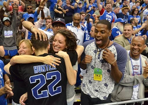 Georgia State's R.J. Hunter (22) celebrates with fans as he leaves the court after he made the game-winning shot against Baylor on Thursday, March 19, 2015, in Jacksonville, Fla. Georgia State won 57-56.