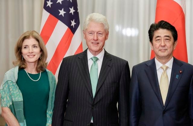 Former U.S. President Bill Clinton (C) poses for a photograph with U.S. Ambassador to Japan Caroline Kennedy (L) and Japanese Prime Minister Shinzo Abe before a welcome dinner hosted by Abe at Abe's residence in Tokyo March 17, 2015. REUTERS/Kimimasa Mayama/Pool